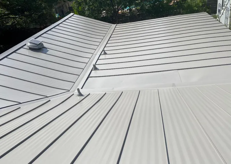 Solar attic fan installed on a metal roof for Roof Ventilation in Volo